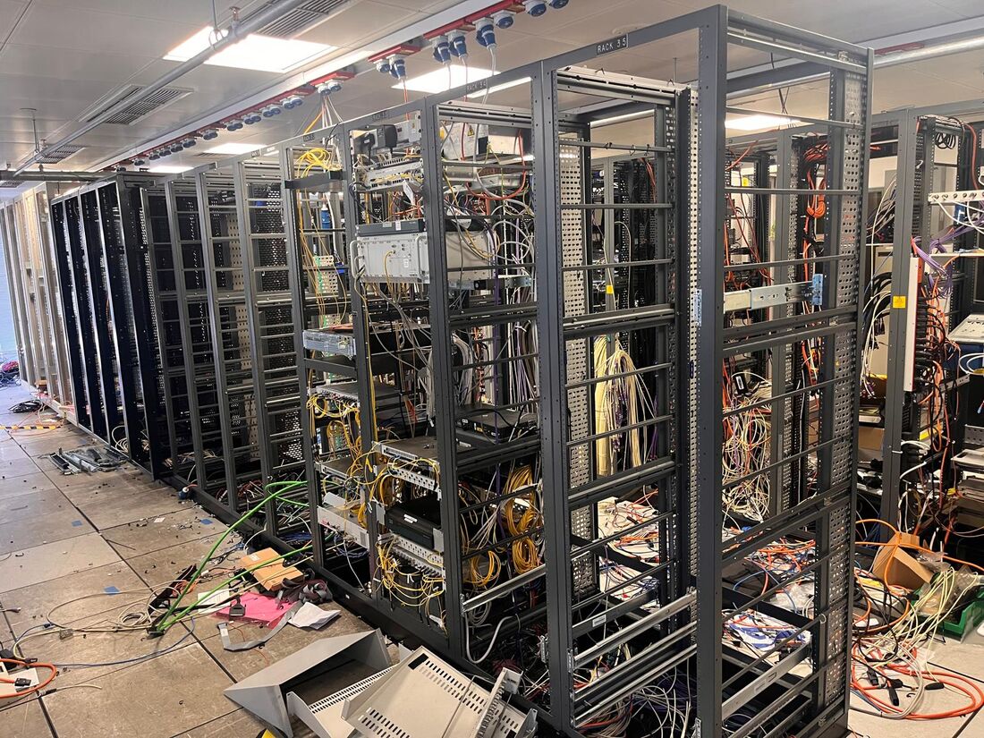 Server room racks with cabling being cleared
