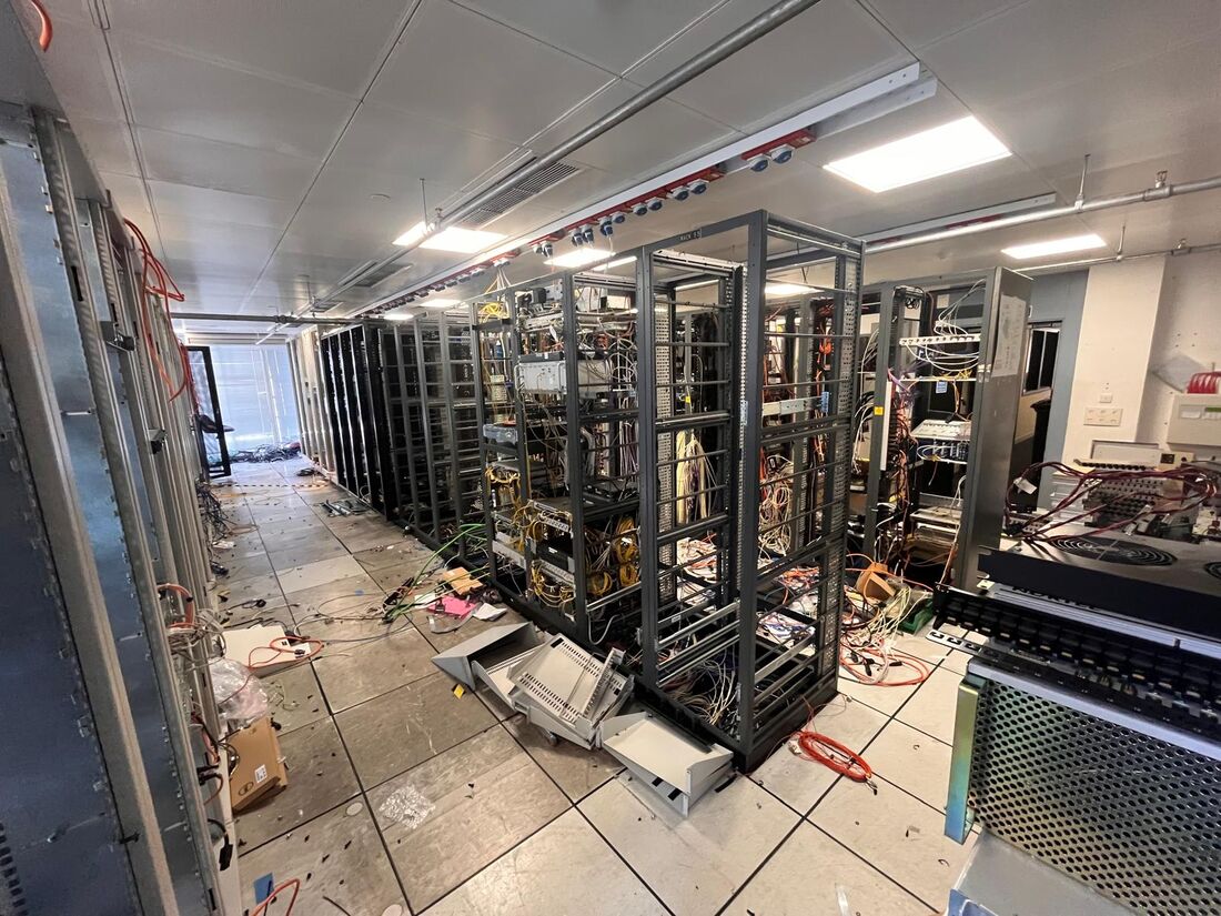 Server room row partially stripped of equipment